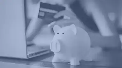 a native american store owner holding a credit card and piggy bank